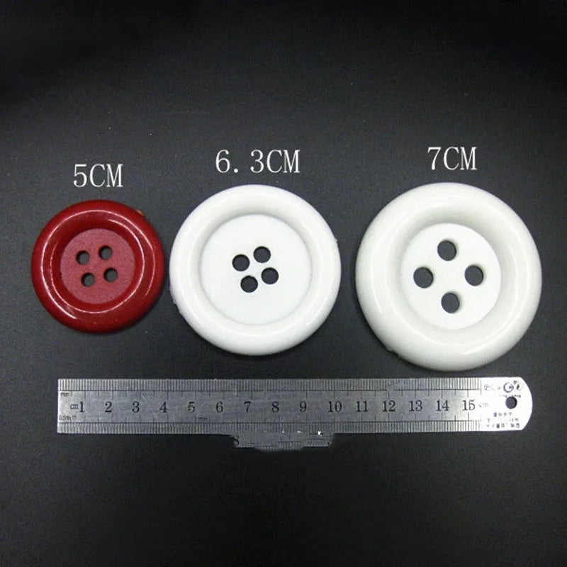 Oversized round plastic nylon button with four holes in various colours and sizes