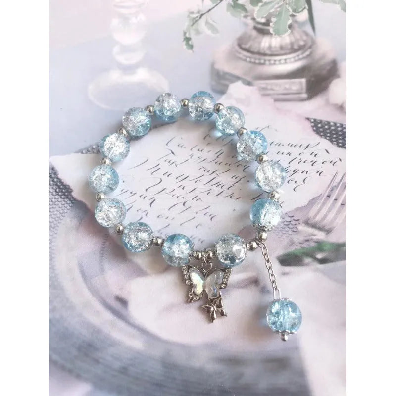 Chinese style handmade glass bead bracelet with bamboo joint elements on a white background.
