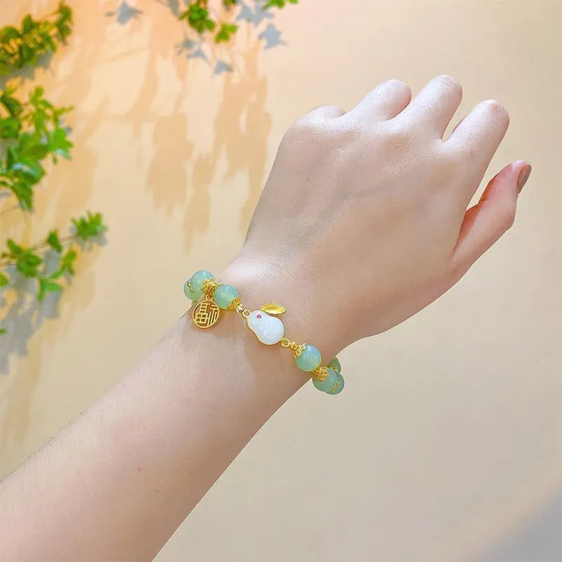 Chinese style handmade glass bead bracelet with bamboo joint elements on a white background.