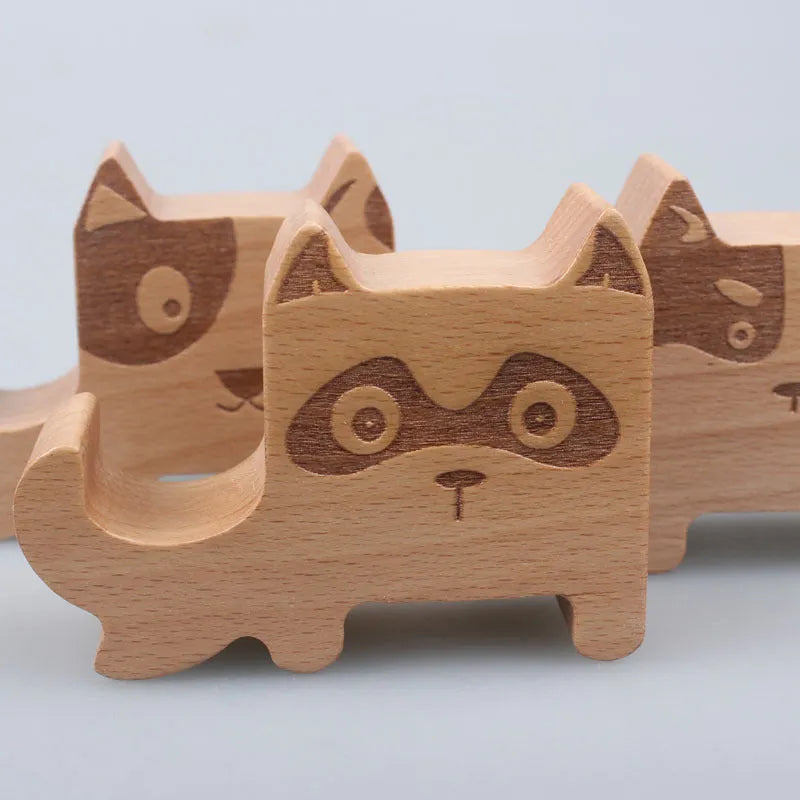 Beech wood mobile phone holder with resin animal decoration and custom lettering on coin back.