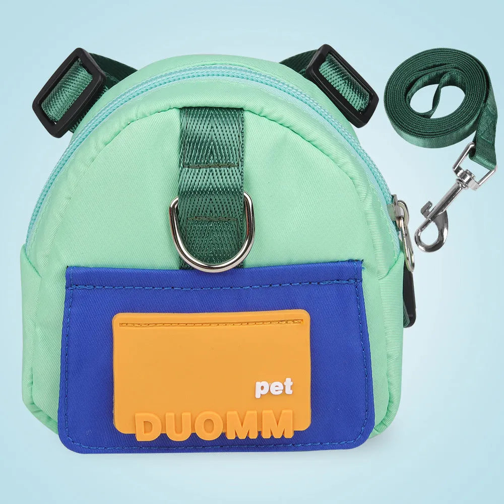 Blue adjustable dog backpack harness with storage compartments and a tow rope attached.