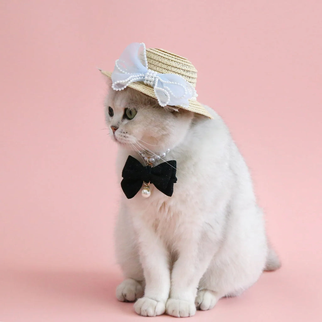 Woven straw hat for cats with pearl butterfly bow in princess style, shown in pink colour