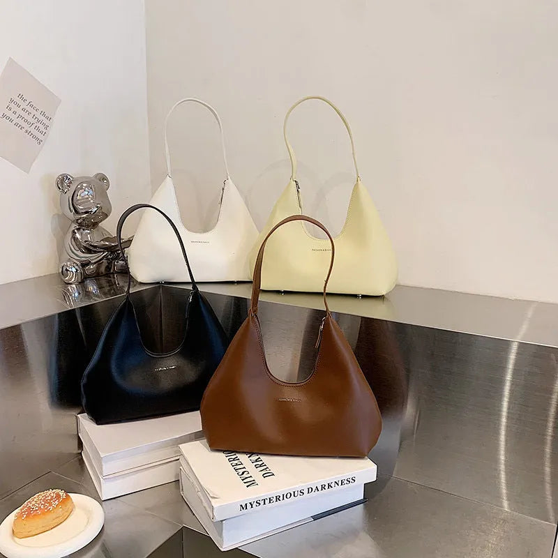 Brown retro PU shoulder handbag showing pillow shape, single strap, and organised interior with mobile phone pocket