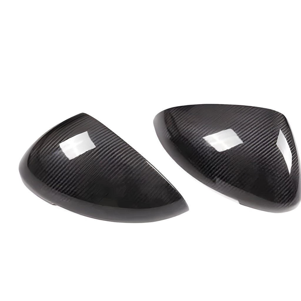 Genuine carbon fibre rearview mirror covers for a Porsche Macan, showing glossy black weave texture.