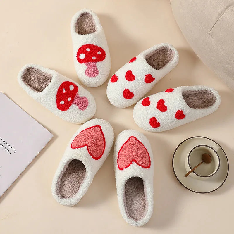 Women's plush home slippers in cartoon love style print with round toe and non-slip PVC sole.