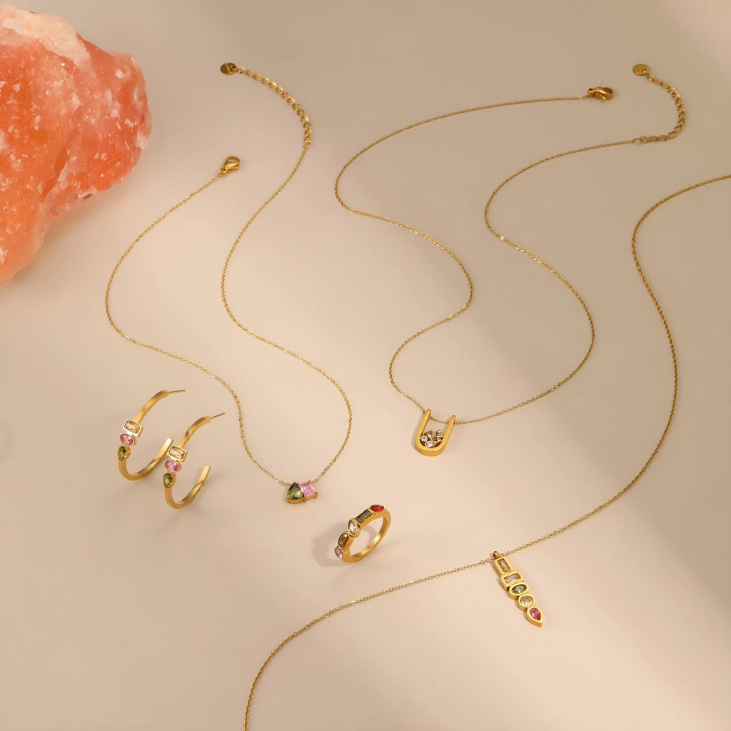 Geometric 18K gold plated jewellery set showing necklace, ring and earrings with zircon elements