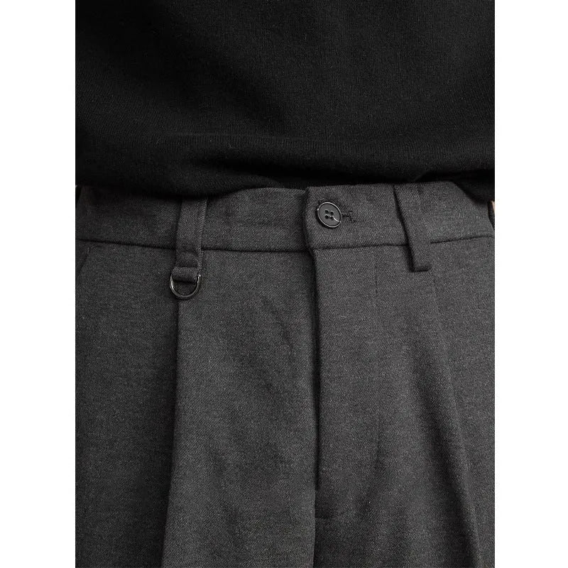 Men's straight-leg polyester trousers in black, shown in a business casual setting.