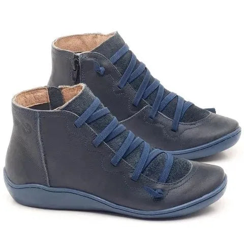 Women's black casual ankle boot with a flat wedge heel and round toe on a plain background.