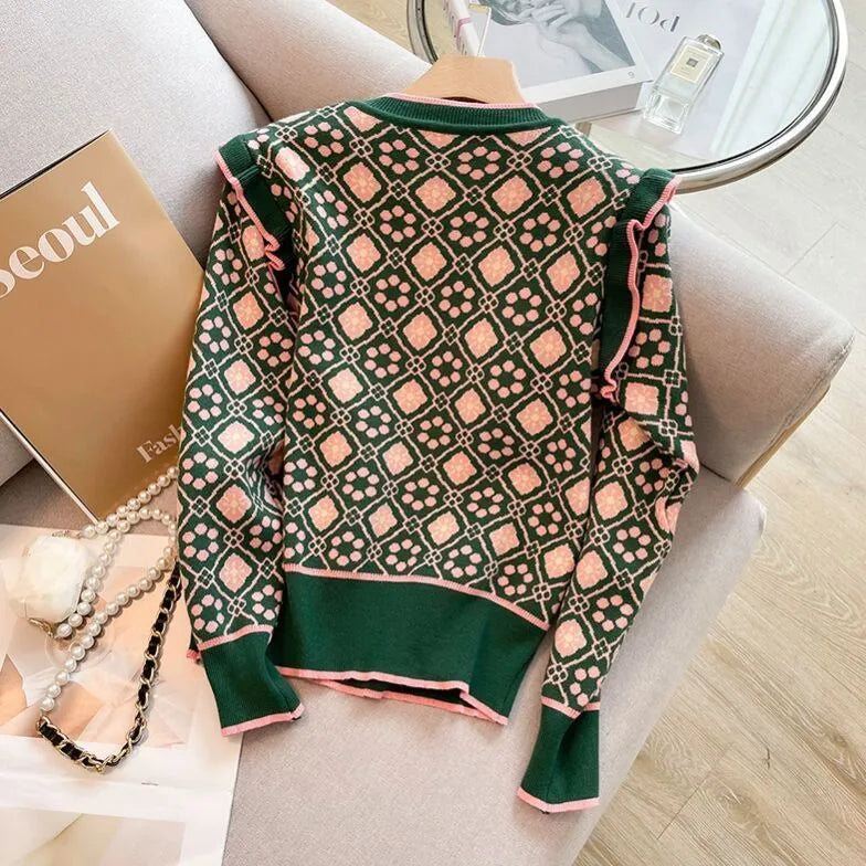 Green printed loose-fit women's jumper with regular sleeves on a hanger
