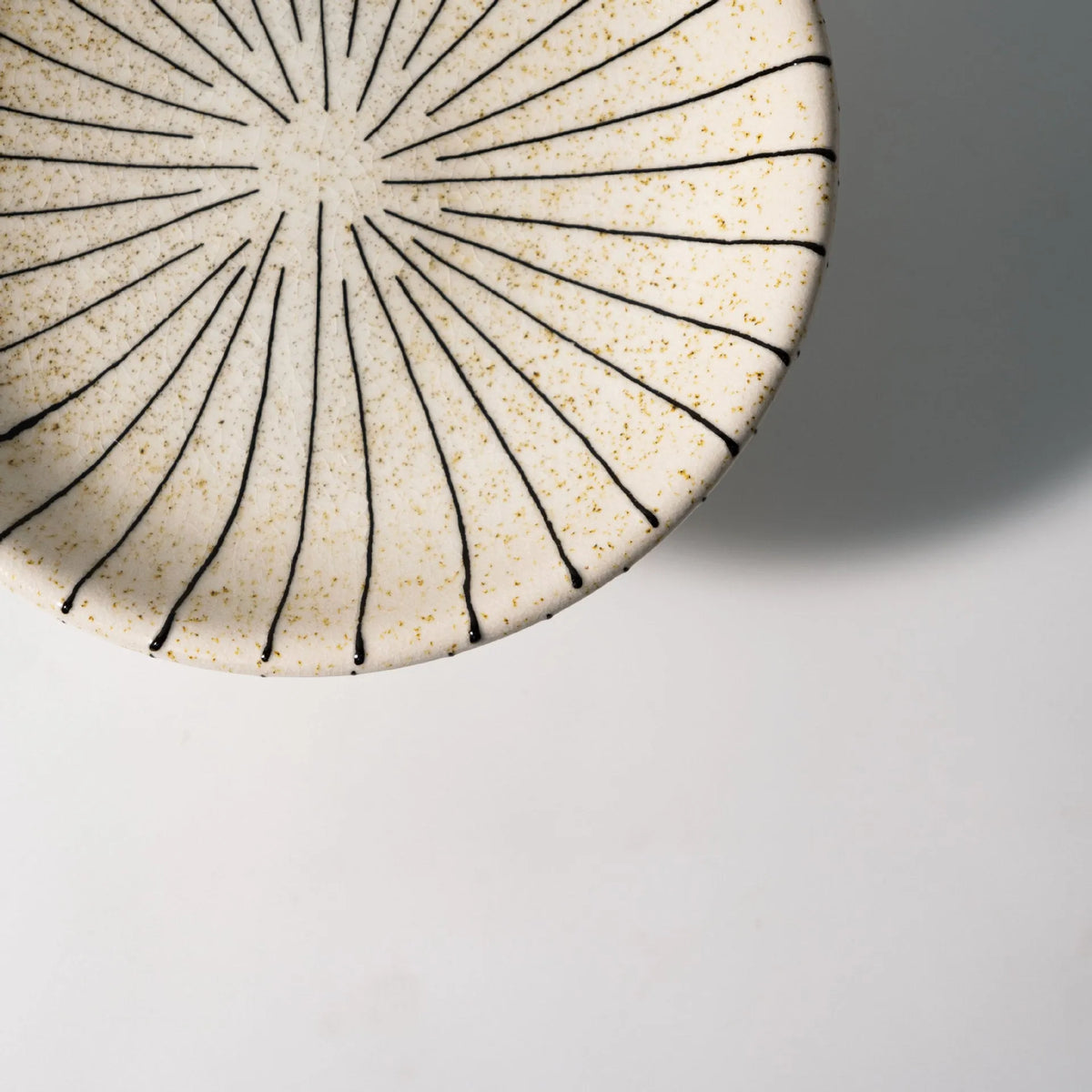 Black and white striped retro synthetic resin dessert plate on a table.