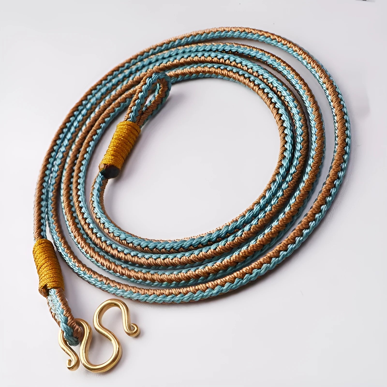 Gold peace buckle necklace with imitation pearl pendant and gemstone inlay on adjustable cord