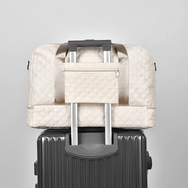 Oxford cloth travel bag in a solid colour with sewing thread detail, shown with 36-55L capacity.
