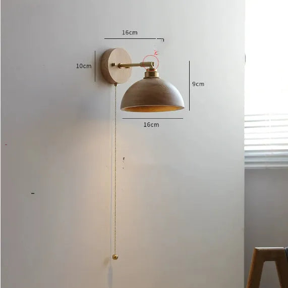 Nordic style wooden bedside wall lamp in walnut colour mounted on a wall.