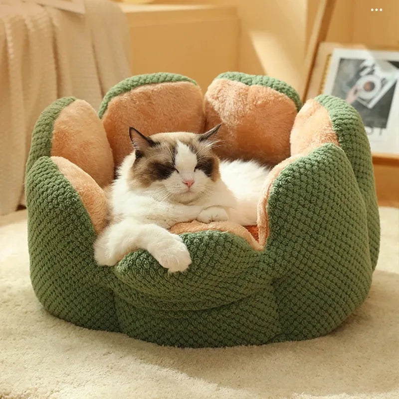 Grey petal-shaped plush kennel bed for cats and dogs on a hardwood floor.