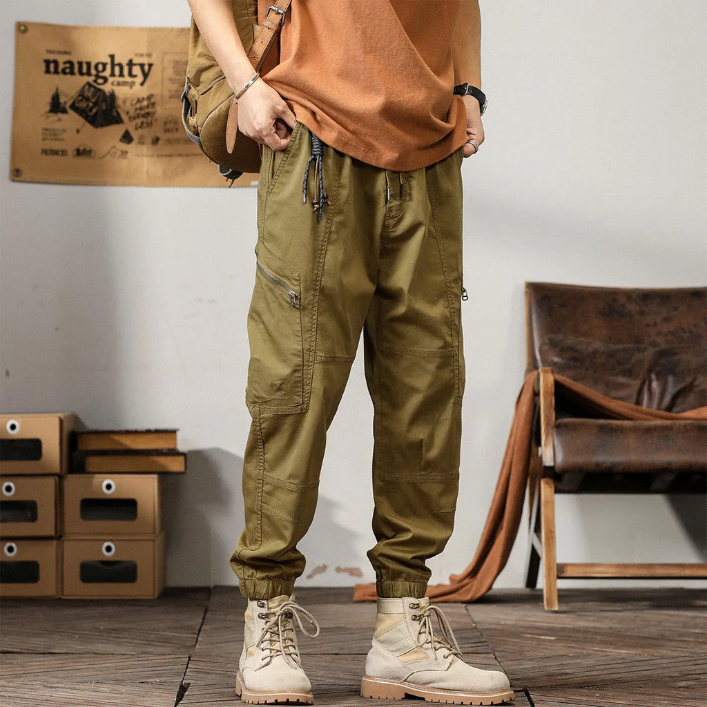 Men's cotton harem pants in khaki with tapered legs and ankle band.