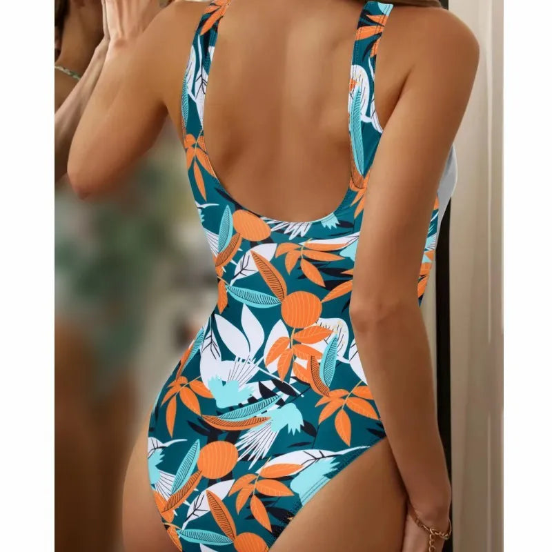 Women's high-waist one-piece swimsuit in a printed pattern, showing conservative cut and style.