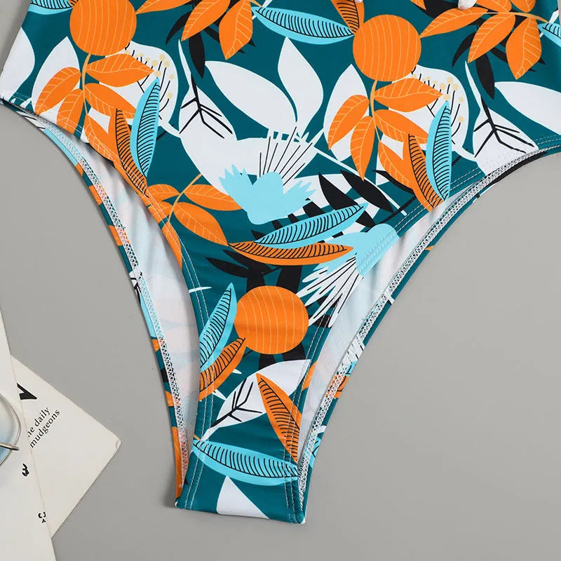 Women's high-waist one-piece swimsuit in a printed pattern, showing conservative cut and style.