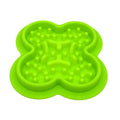 Silicone pet licking pad slow feeder mat in various colours on a floor