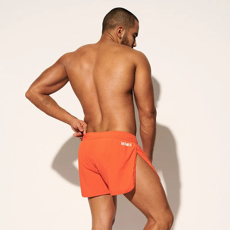 Men's loose-fitting orange polyester beach trousers for surfing and casual summer wear