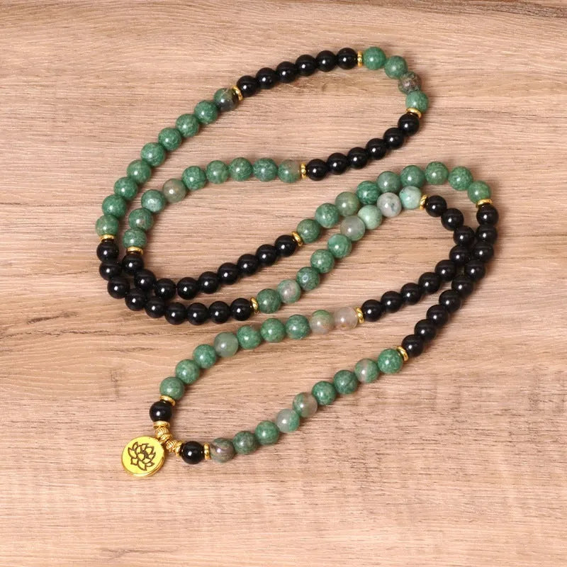 Green and black alloy beaded bracelet with elastic closure showing natural style design