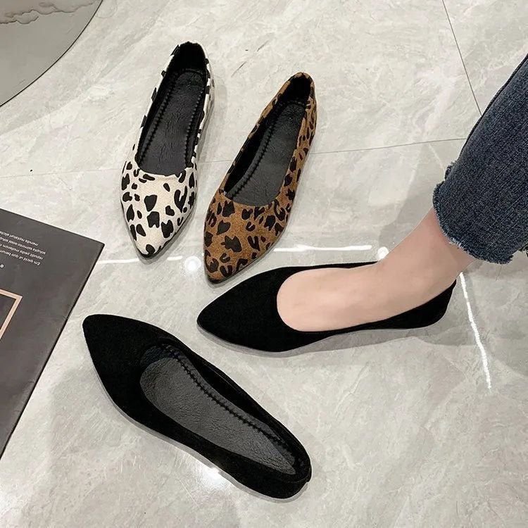 Women's leopard print flat pointed toe pumps with low heel on a rubber sole.