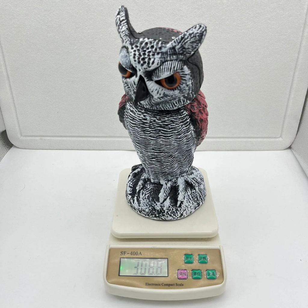 PE plastic artificial owl bird deterrent ornament with shaking head in outdoor garden setting
