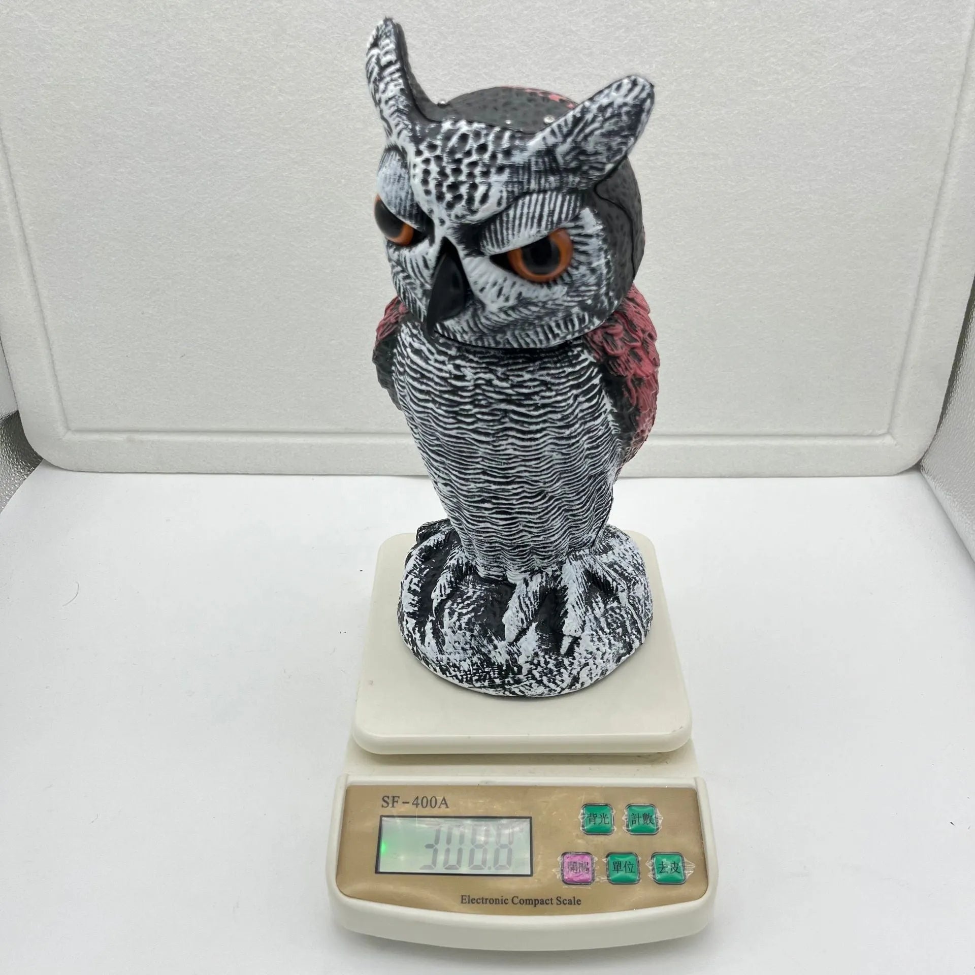 PE plastic artificial owl bird deterrent ornament with shaking head in outdoor garden setting