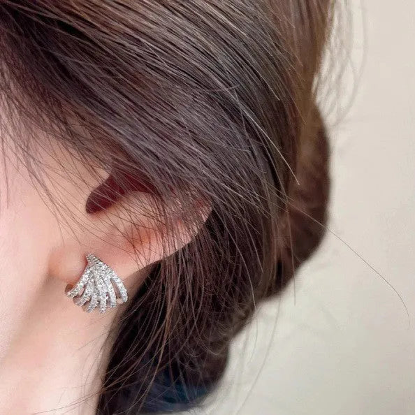 Pair of geometric line design earrings with platinum electroplated finish on zircon.