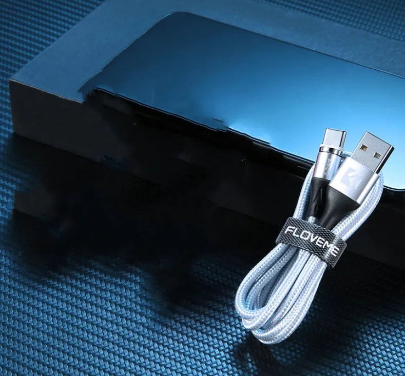 Black magnetic fast-charge data cable with glowing side lights next to a smartphone.