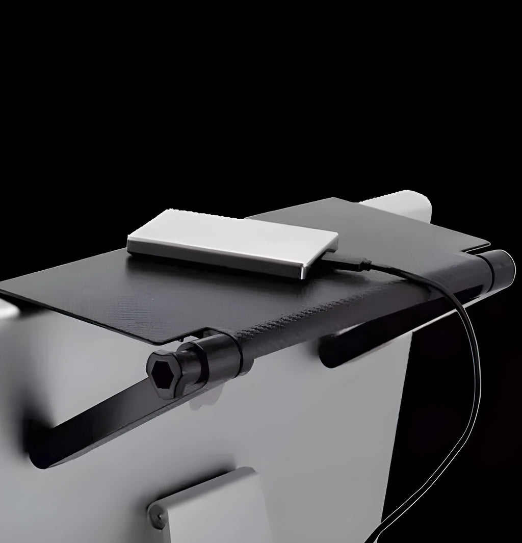 Black adjustable 13-inch screen top shelf mounted above a monitor, holding a streaming device and remote.