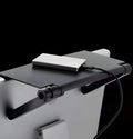 Black adjustable 13-inch screen top shelf mounted above a monitor, holding a streaming device and remote.