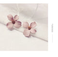 Flower-shaped stud earrings in white or pink colour with electroplated alloy construction
