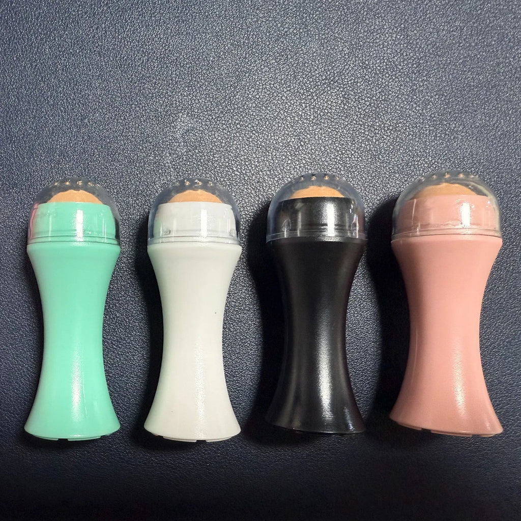 Portable volcanic stone facial roller for oily skin control in black, green, pink, or white.