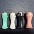 Portable volcanic stone facial roller for oily skin control in black, green, pink, or white.