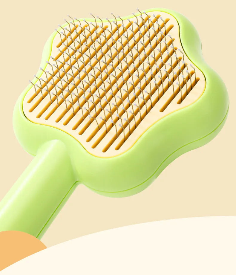Green or yellow self-cleaning cat comb with stainless steel teeth, showing 20cm length.