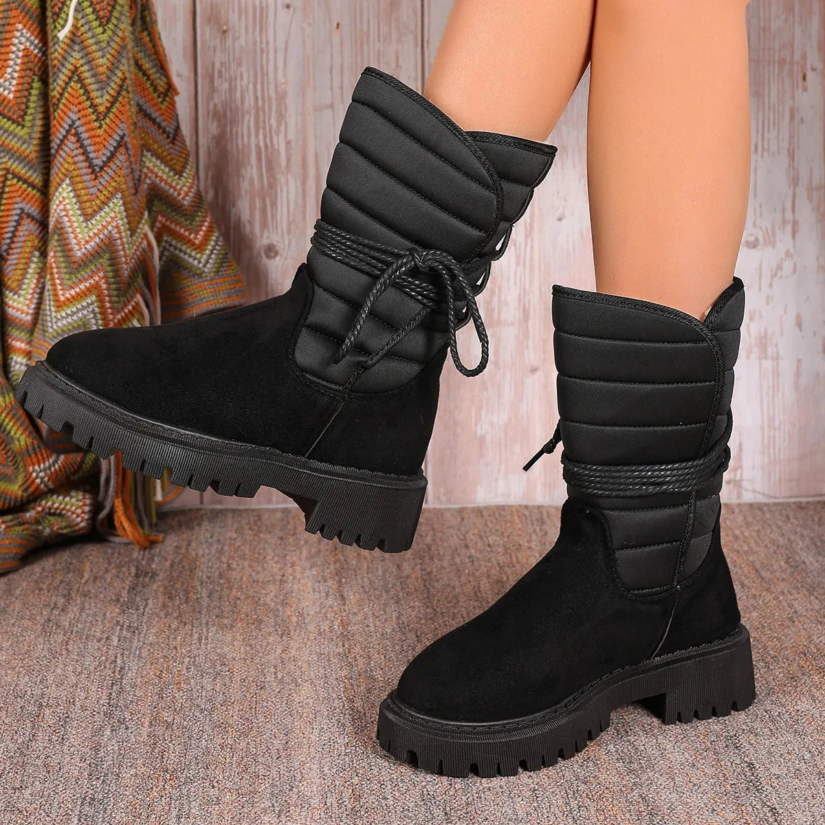 Women's black suede snow boots with chunky heel, lace-up front, and fleece lining.
