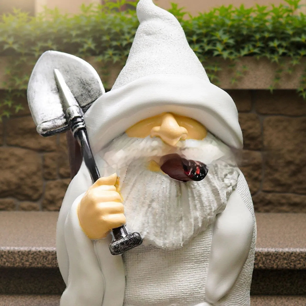 Close-up of a smoking shovel dwarf resin Christmas ornament with pipe, for garden or tree decoration.
