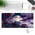 Large black gaming mouse pad with geometric pattern measuring 400x900mm on wooden desk