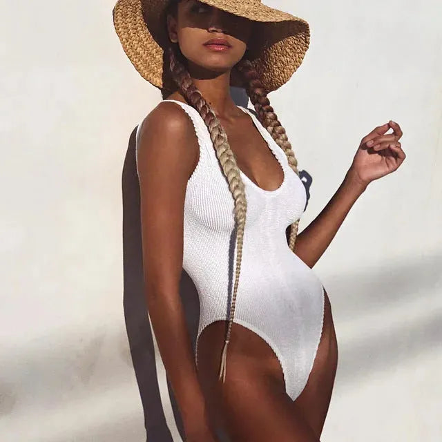 Women's solid colour seersucker one-piece swimsuit with backless design.