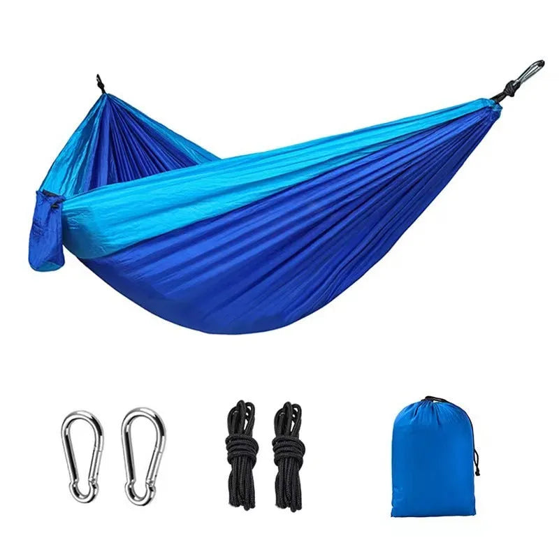 Blue nylon parachute cloth camping hammock measuring 270x140cm suspended outdoors