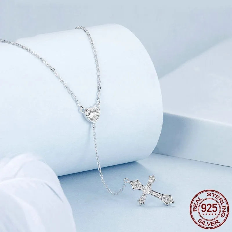 Women's silver cross necklace with V-neck design and O-ring chain.