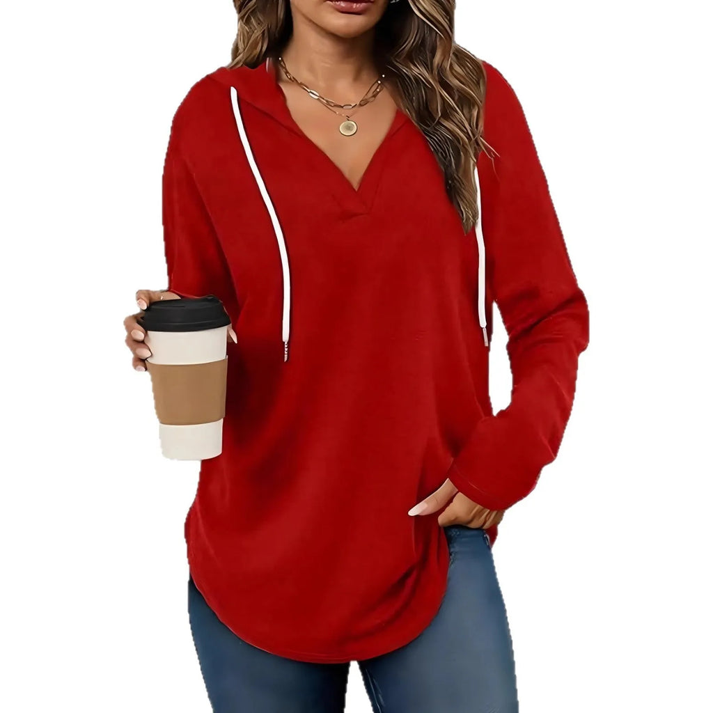 Women's red V-neck sweatshirt with hood showing loose fit and regular-length sleeves