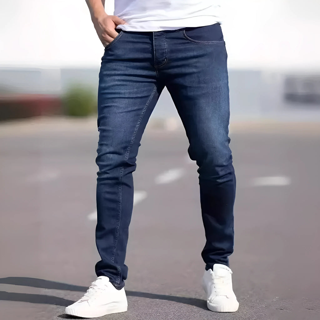 Men's dark blue slim-fit casual jeans with skinny leg and zip fly.