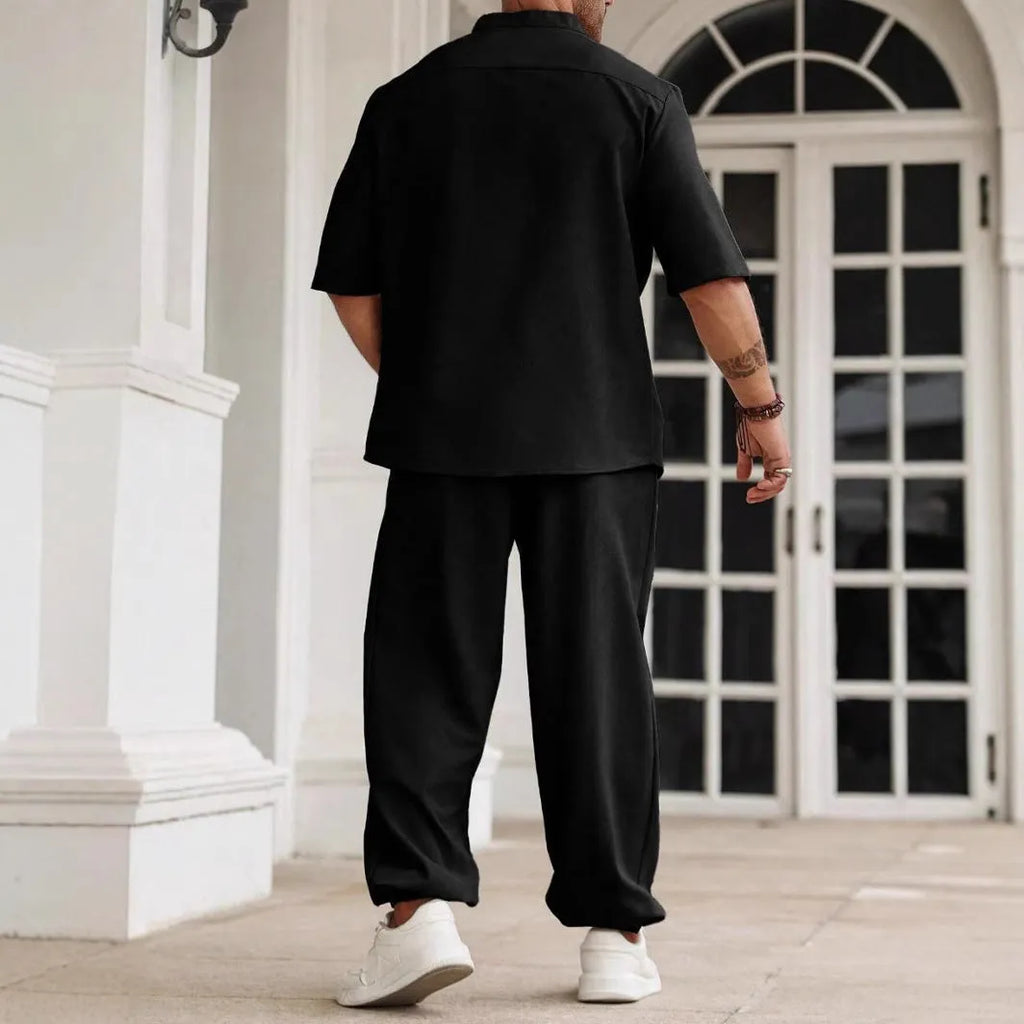 Men's apricot coloured cotton linen short sleeve shirt and matching casual trousers laid flat.