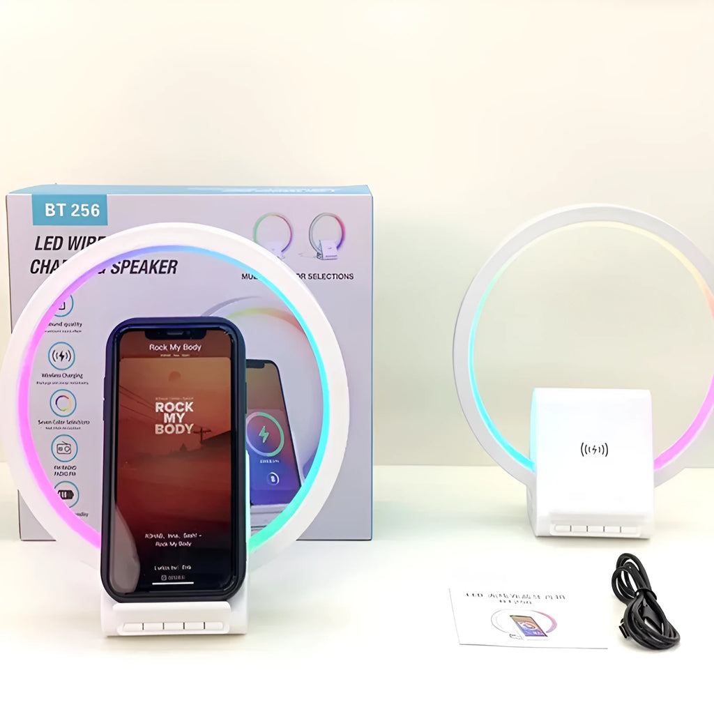 White smart Bluetooth speaker with wireless charging pad and ambient light on top.