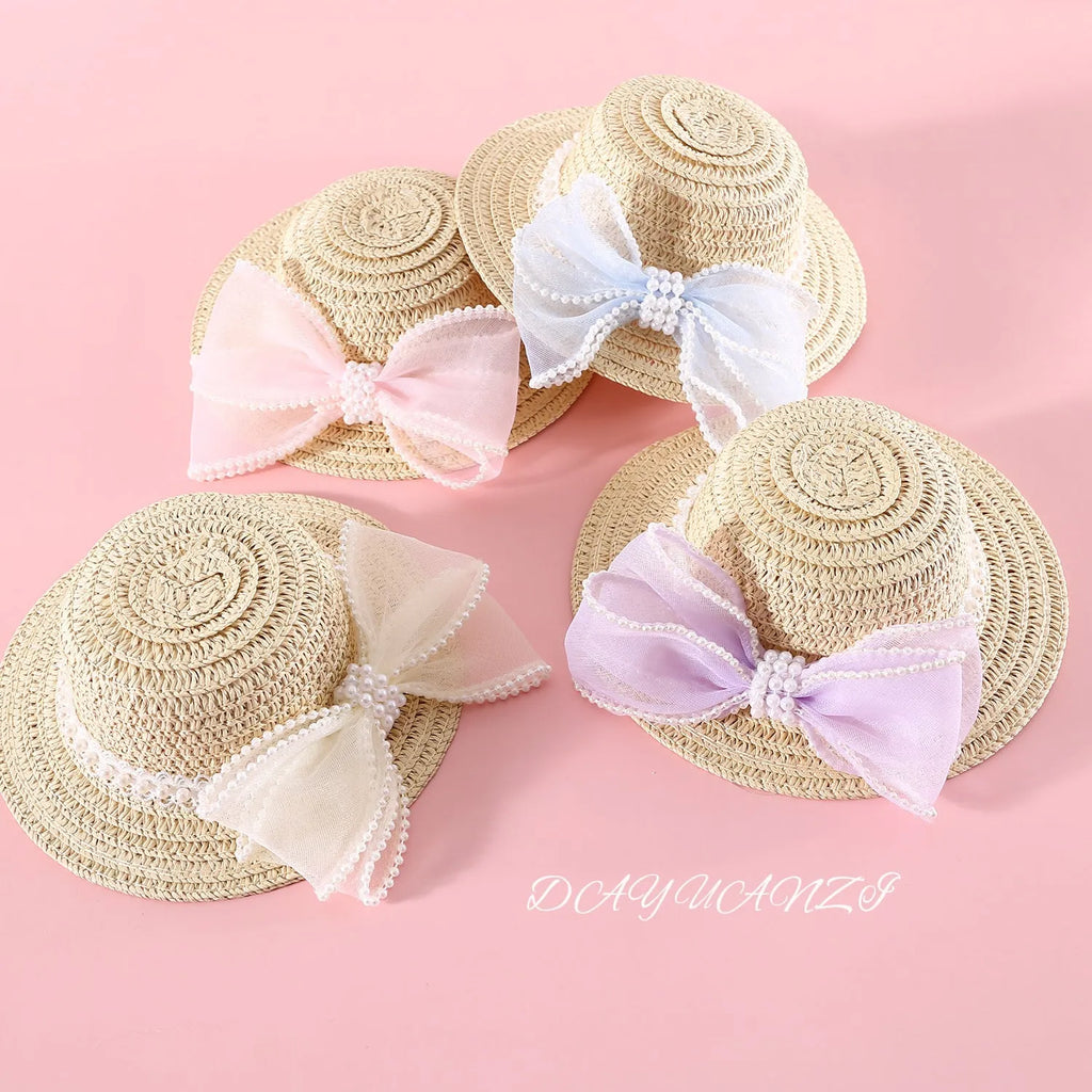 Woven straw hat for cats with pearl butterfly bow in princess style, shown in pink colour