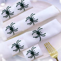Six black spider-shaped alloy napkin rings for Halloween table decoration