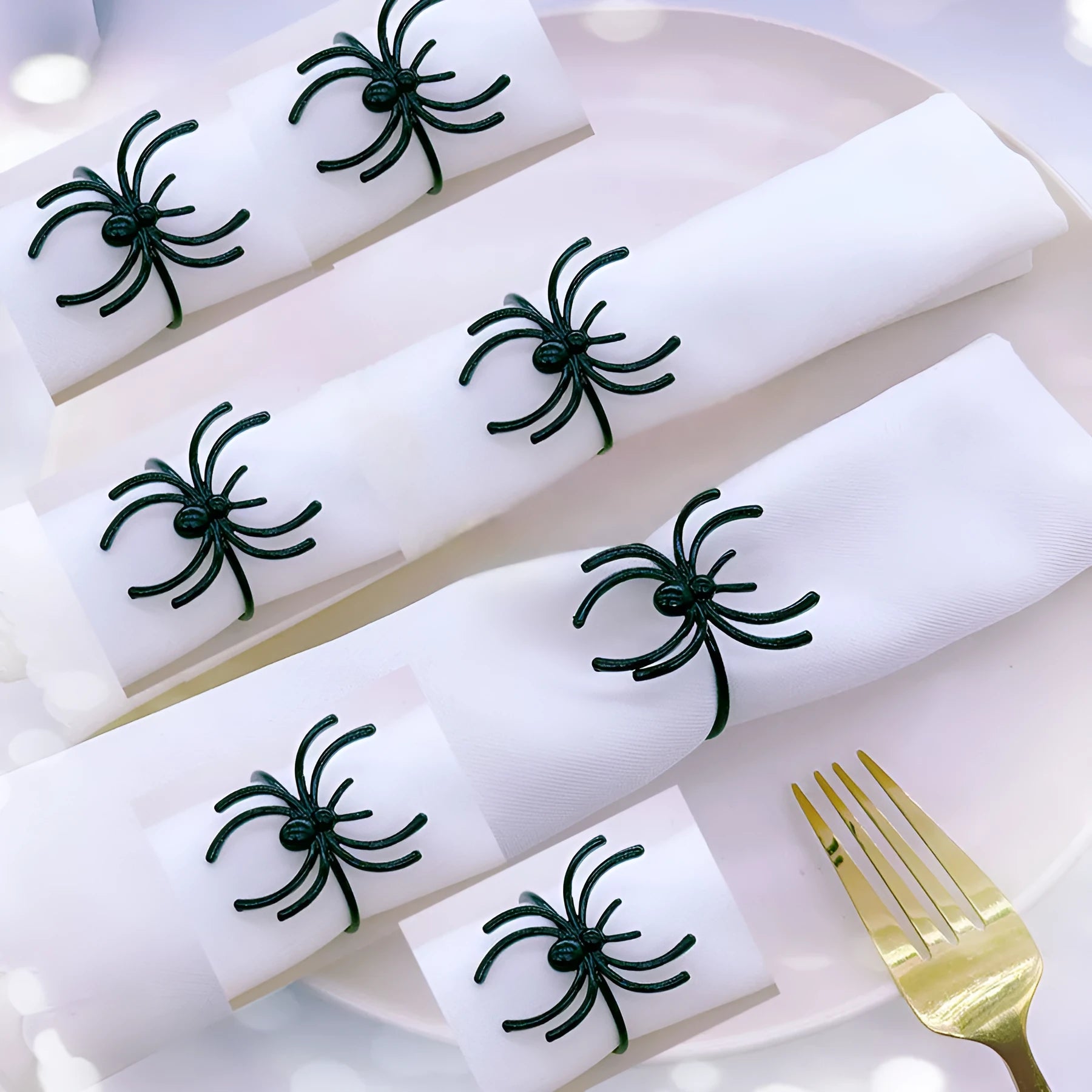 Six black spider-shaped alloy napkin rings for Halloween table decoration