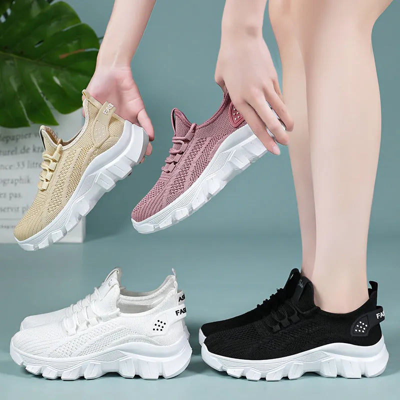 Women's white Flyknit sneakers with thick PVC sole and lace-up front.