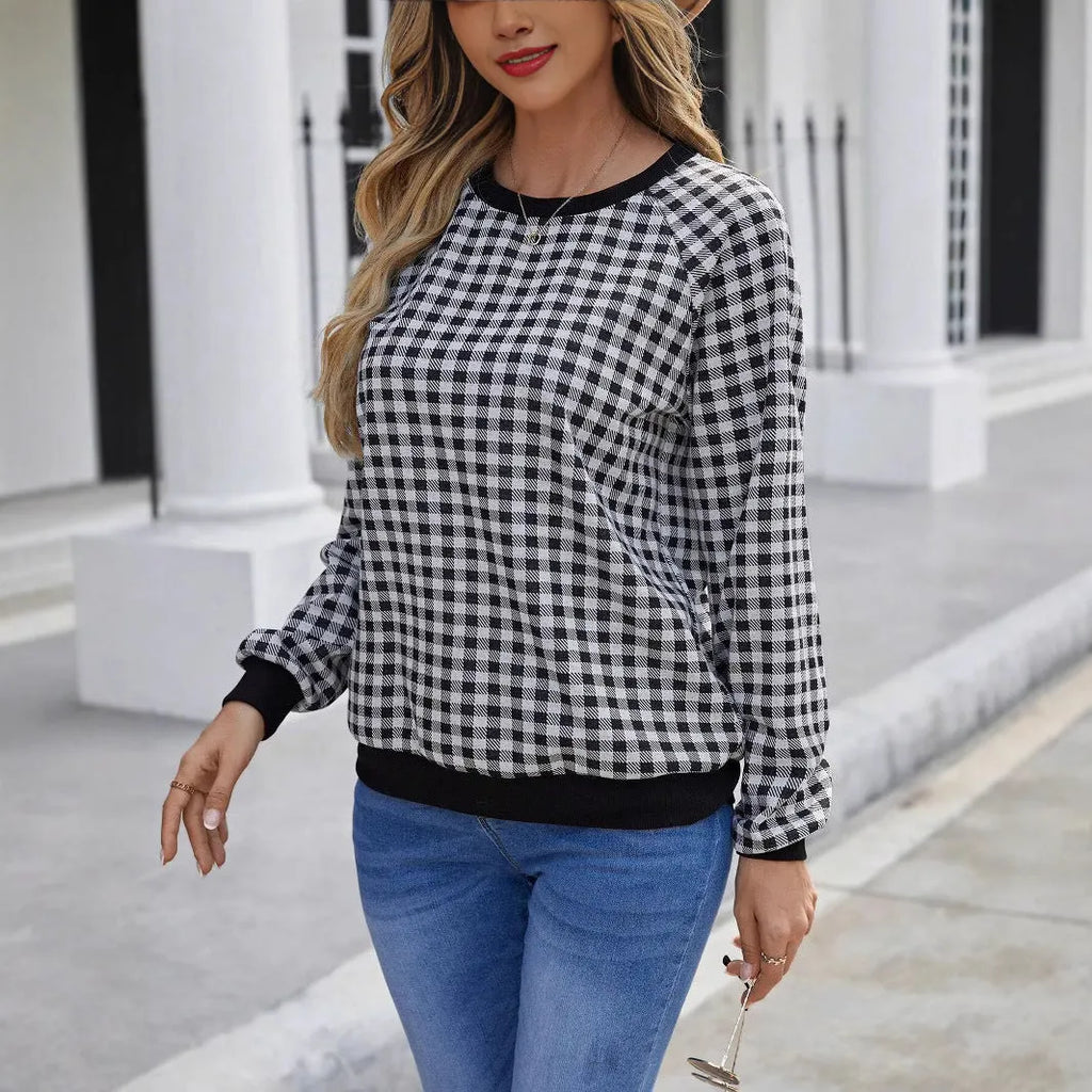 Black polyester pullover sweater with a plaid printed pattern and long sleeves.